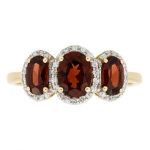 Gen. Garnet Oval 6x4/5x3 & .17TCW Diamond Trio Ladies Ring 10KT