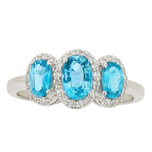 Gen. Blue Topaz Oval 6x4/5x3 & .17TCW Diamond Trio Ladies Ring 10KT WG