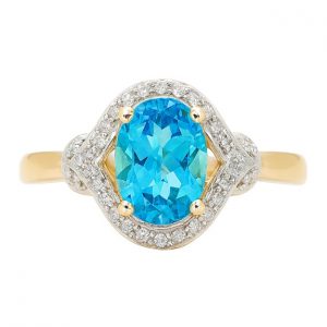 Gen. Blue Topaz Oval 8x6 & .10TCW Diamond Ladies Ring 10KT