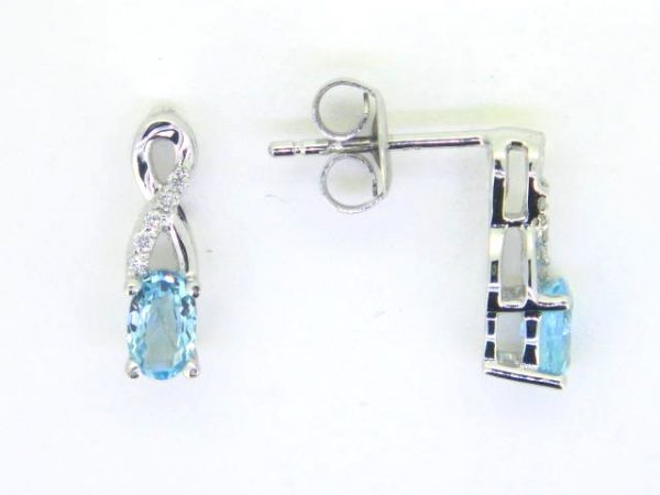 Genuine Blue Topaz 5x3 & .05TCW Diamond Accented Infinity Design Stud Earrings 10KT WG   *FINAL SALE*